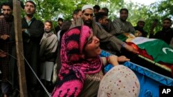 A relative cries during the funeral of civilian Adil Magray at Shopian, about 60 kilometers (38 miles) south of Srinagar, Indian controlled Kashmir, June 7, 2017. 