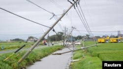 Power poles damaged due to strong winds caused by Typhoon Goni are seen in Kamimine town, Saga Prefecture, Japan, in this photo taken by Kyodo August 25, 2015.