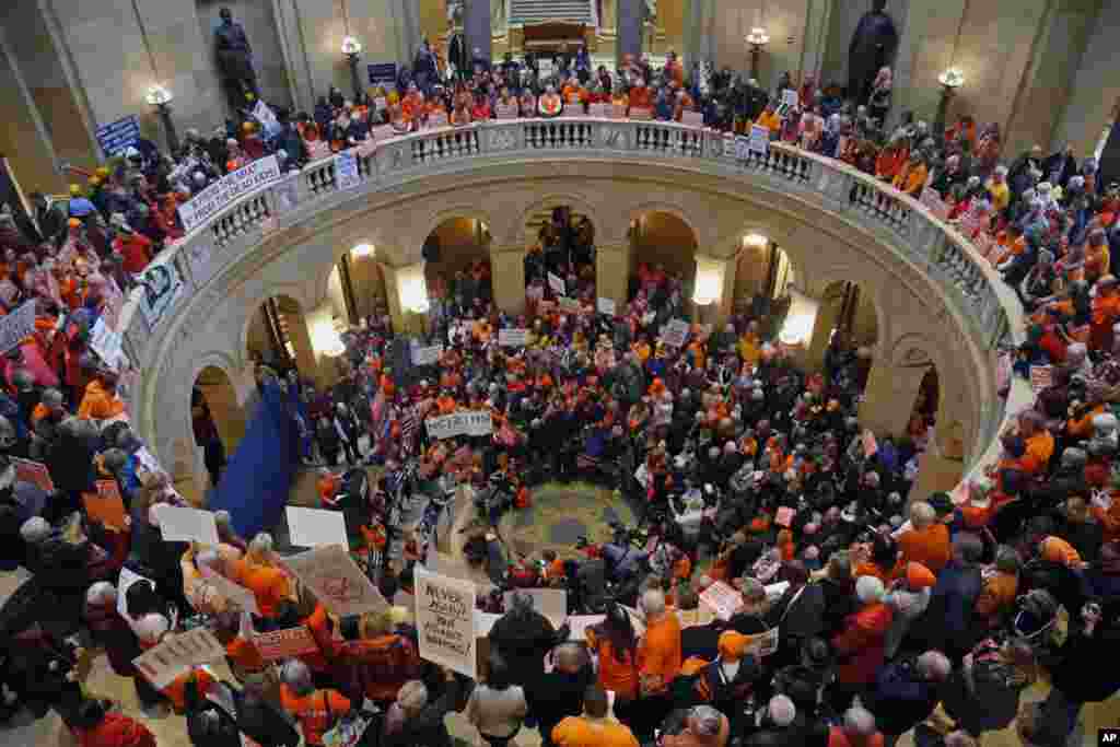 Hundreds gather in the State Capitol rotunda during a rally Thursday, Feb. 22, 2018 in St. Paul, Minn., where concerned citizens are calling for the passage of four bills they believe would substantively reduce gun violence in the state. 