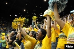FILE -- Students cheering on the Patriots basketball team in the Patriot Center at George Mason University in Fairfax, Virginia. (Photo by George Mason Business)