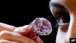 The Pink Star diamond, the most valuable cut diamond ever offered at auction is displayed by a model at Sotheby's auction rooms in London, Monday, March 20, 2017.