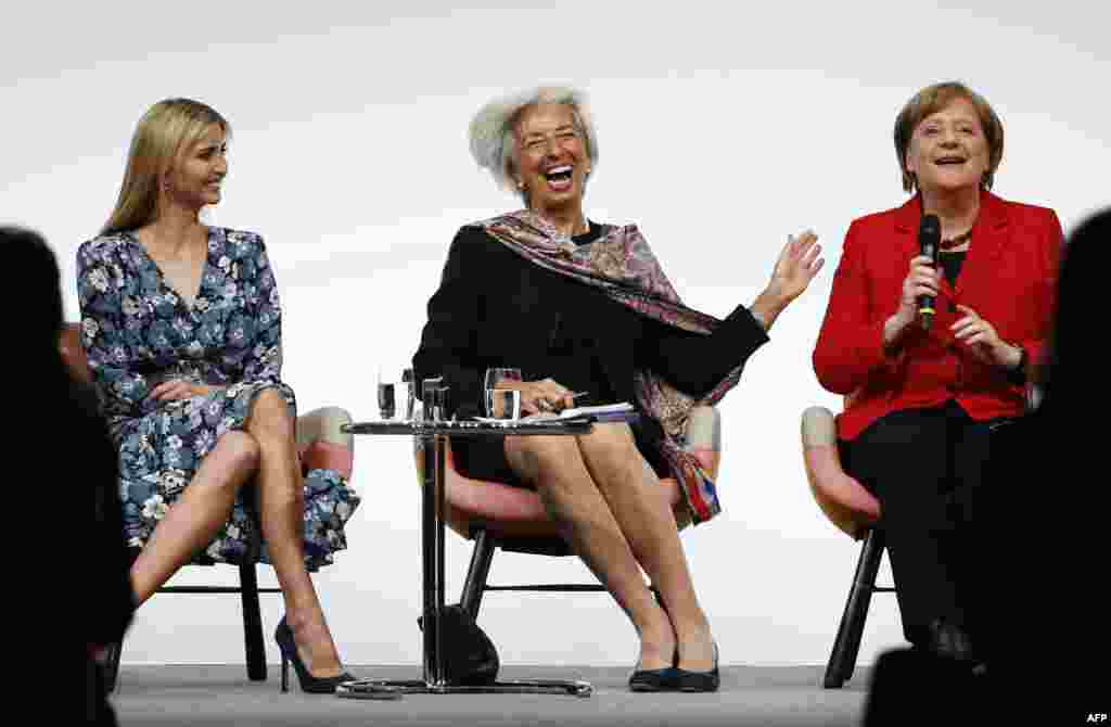 First Daughter and Advisor to the US President Ivanka Trump, Managing Director of the International Monetary Fund (IMF) Christine Lagarde and German Chancellor Angela Merkel share a laugh at the start of a panel discussion at the W20 women's empowerment s