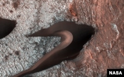 The High Resolution Imaging Science Experiment (HiRISE) camera aboard NASA's Mars Reconnaissance Orbiter often takes images of Martian sand dunes to study the mobile soils. These images provide information about erosion and movement of surface material, a