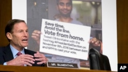 Sen. Richard Blumenthal, D-Conn., speaks next to a poster depicting an online ad that attempted to suppress votes as Facebook general counsel Colin Stretch, Twitter acting general counsel Sean Edgett and Google information security director Richard Salgado testify before a Senate subcommittee on Capitol Hill in Washington, Oct. 31, 2017, on more signs from tech companies of Russian election activity.