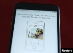 FILE - The dating app Tinder is shown on an Apple iPhone.