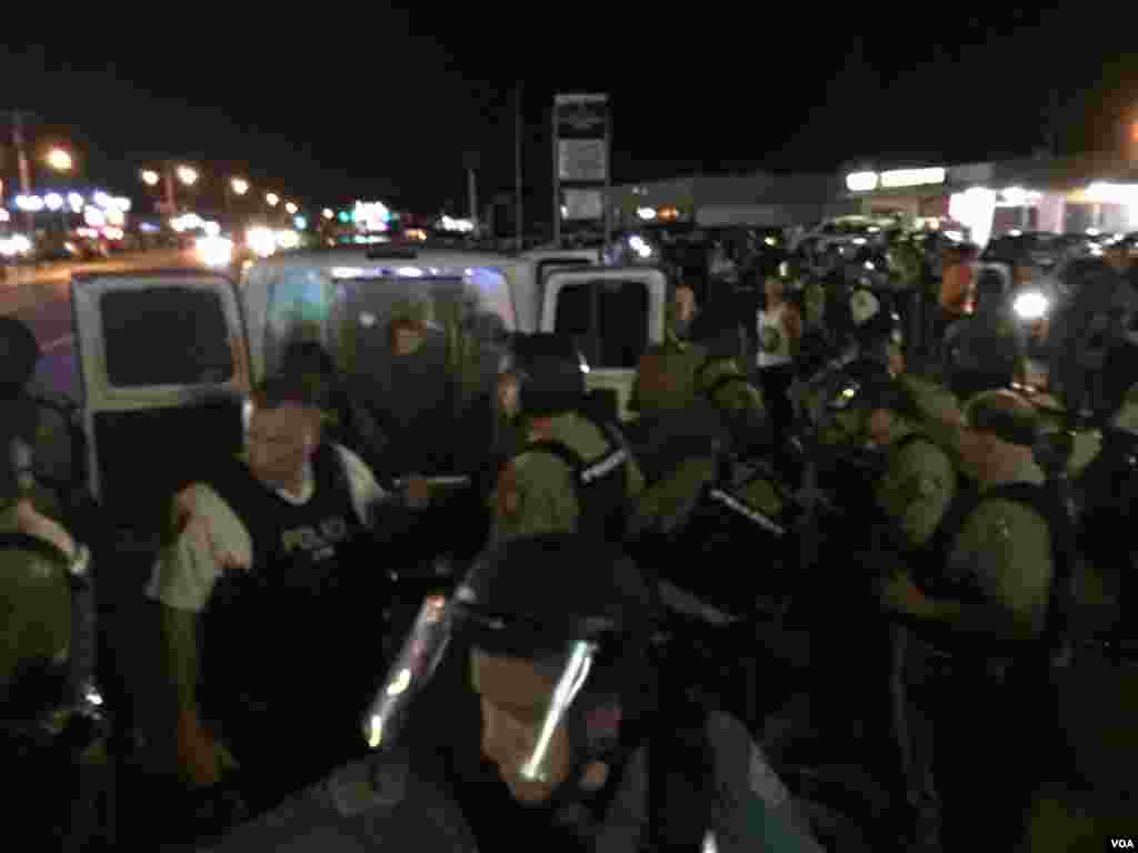 Police make an arrest on West Flourissant in Ferguson, Missouri, August 10, 2015. (Kane Farabaugh/VOA News)