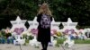 A person stands in front of Stars of David that are displayed in front of the Tree of Life Synagogue with the names of those killed in Saturday's shooting in Pittsburgh, Oct. 29, 2018.