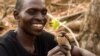 A Yao honey hunter holds a male Greater Honeyguide