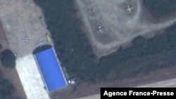 This handout satellite image taken on Nov. 22, 2021, by Planet Labs PBC shows what Dutch peace organization PAX says are two Chinese-origin Wing Loong drones parked at Hara Meda airbase in Bishoftu, Ethiopia. (Planet Labs PBC/AFP)