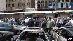 Burnt out cars at site of blast in Damascus June 28, 2012