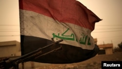 1일 이라크 모술 동부 바르틸라에서 모래 폭풍 속에 이라크 국기가 휘날리고 있다.