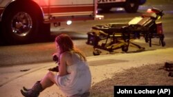 A woman sits on the street at the scene of a shooting outside of a music festival along the Las Vegas Strip. Months after Facebook and Google announced major efforts to curb the spread of false stories pretending to be news, it’s still a problem, most rec