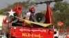 Supporters of Myanmar ruling National League for Democracy party ride on a truck displaying banner that reads: "To continue change, let's vote NLD" during a campaign for the upcoming by-election, March 19, 2017, in the outskirts of Yangon, Myanmar.