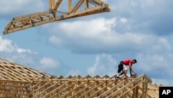 Construction workers build a commercial complex in Springfield, Illinois, in this July 17, 2014 photo.