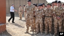 British Prime Minister Gordon Brown (L) arrives to greet soldiers at Lashkar Gah base, Helmand Province, Afghanistan, 06 Mar 2010