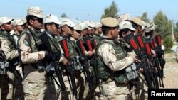 FILE - Kurdish Peshmerga fighters take part during a training session by coalition forces in a training camp in Irbil, north of Iraq, March 9, 2016.