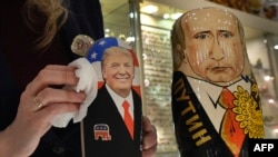 An employee polishes traditional Russian wooden nesting dolls depicting Donald Trump (L), U.S. president-elect at the time, and Russian President Vladimir Putin at a gift shop in central Moscow, Russia, Jan. 16, 2017.