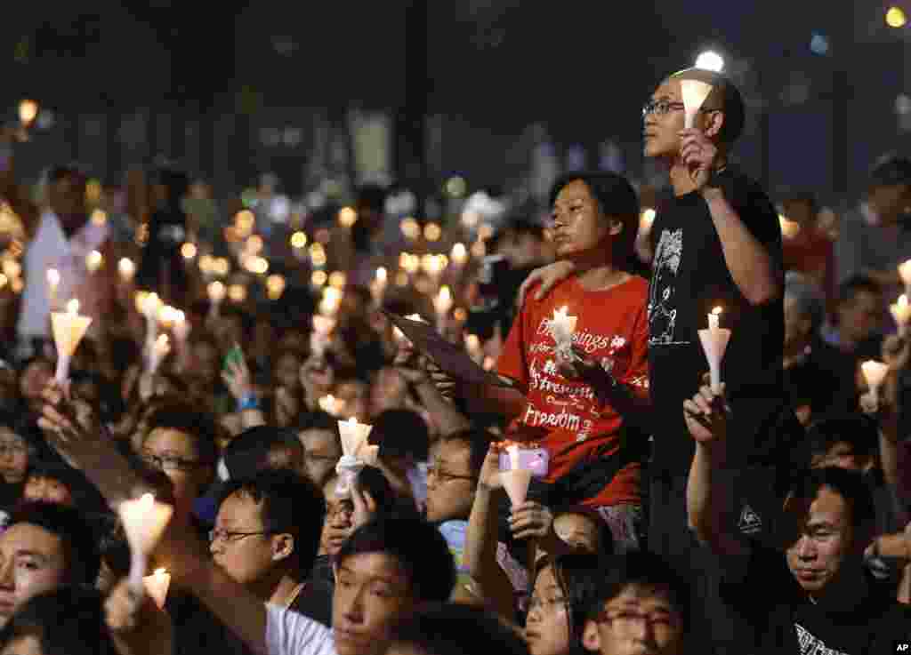 People attend a candlelight vigil at Hong Kong's Victoria Park Monday, June 4, 2012 to mark the 23rd anniversary of the Chinese military crackdown on the pro-democracy movement in Beijing. 