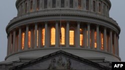 A U.S. flag flies at half-staff in front of the U.S. Capitol in tribute to former U.S. President George H. W. Bush, early on Dec. 2, 2018, in Washington.