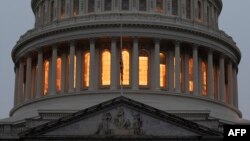 A U.S. flag flies at half-staff in front of the U.S. Capitol in tribute to former U.S. President George H. W. Bush, early on Dec. 2, 2018, in Washington.