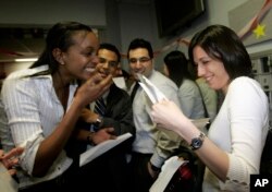 FILE - Boston University medical students Miriam Shiferaw, left, and Nawal Momani check letters together to find out where they have been accepted for their residency during Match Day at Boston University Medical School in Boston, March, 15, 2007. According to this year's data, of 42,000 applicants vying for residencies, all but about 6,000 are foreign nationals.