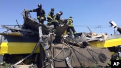 Italian firefighters search among debris at the scene of a train accident after two commuter trains collided head-on near the town of Andria, in the southern region of Puglia, killing several people, July 12, 2016.