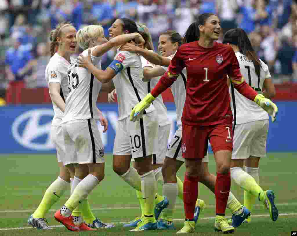 United States&#39; Carli Lloyd (third from left) celebrates with teammates, including goalkeeper Hope Solo (1), after Lloyd scored her third goal against Japan during the first half of the Women&#39;s World Cup soccer championship in Vancouver, July 5, 2015.