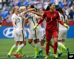 United States' Carli Lloyd (3-L) celebrates with teammates, including goalkeeper Hope Solo (1), after Lloyd scored her third goal against Japan during the first half of the Women's World Cup soccer championship in Vancouver, Canada, July 5, 2015.