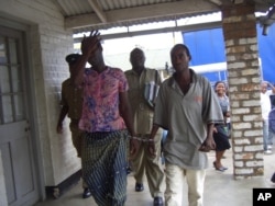 Tiwonge Chimbalanga and Steven Monjeza are taken into custody after celebrating their engagement, December 2009 (photo by Lameck Masina)