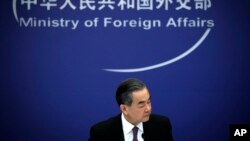 Chinese State Councilor and Foreign Minister Wang Yi reacts during a news conference at the Ministry of Foreign Affairs in Beijing, April 3, 2018.