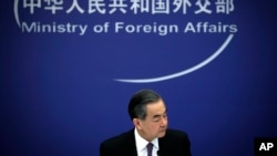 Chinese State Councilor and Foreign Minister Wang Yi reacts during a news conference at the Ministry of Foreign Affairs in Beijing, April 3, 2018.