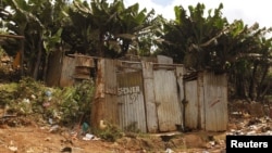 FILE - A public toilet made of rusty sheets of metal stands in Gatwekera village in Kibera slum in Nairobi, Kenya, October 12, 2015. A new project is using solar energy to transform toilet waste into efficient cooking fuel, in an initiative to improve hygiene for people in communities.