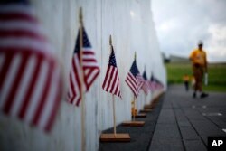 FILE - A visitor to the Flight 93 National Memorial pauses at the Wall of Names containing the names of the 40 passengers and crew of United Flight 93 that were killed in this field on Sept. 11, 2001, nears Shanksville, Pennsylvania, May 31, 2018.