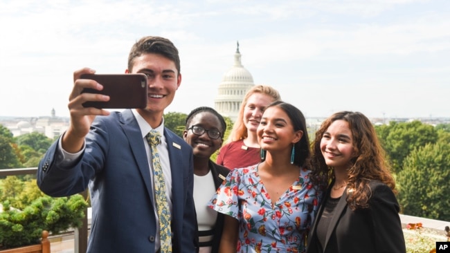 The newly-appointed 2017 Class of National Student Poets, from left, Ben Lee, Juliet Lubwama, Annie Castillo, Kinsale Hueston, and Camila Sanmiguel celebrate with a selfie on the rooftop balcony at the Library of Congress on Thursday, Aug. 31, 2017.