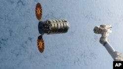 FILE - In this Dec. 9, 2016, file photo made available by NASA via Twitter, a Cygnus spacecraft approaches the International Space Station.