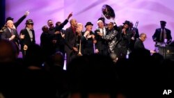 Musicians and speakers sing a grand finale at a tribute for legendary New Orleans composer and recording artist Allen Toussaint, in New Orleans, Louisiana, Nov. 20, 2015.