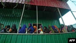 FILE - Newly displaced Somali women queue with their malnourished children as they try to receive medical treatment on outskirts of Mogadishu on April 11, 2017. 