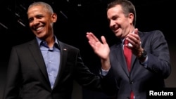 Former U.S. President Barack Obama campaigns in support of Virginia Lieutenant Governor Ralph Northam, right, Democratic candidate for governor, at a rally in Richmond, Virginia, Oct. 19, 2017.