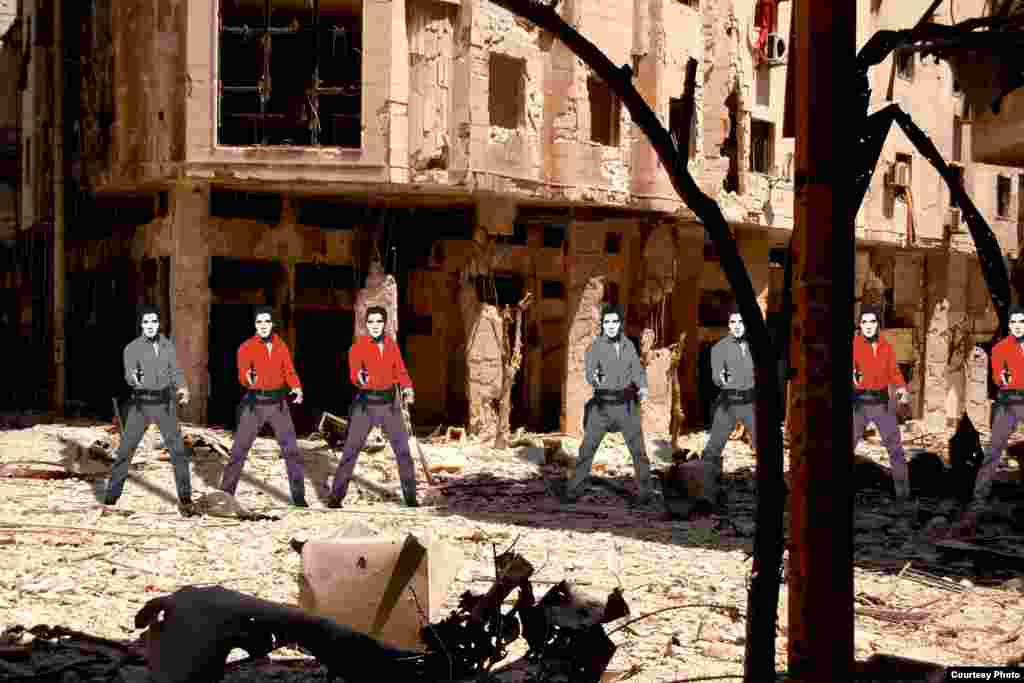 An army of Andy Warhol&rsquo;s &ldquo;Elvis Presley&rdquo; stands defiantly over the rubble of a building in Homs, the nation&rsquo;s third-largest city in Syria and a devastated center of the rebellion. By Tammam Azzam.