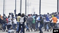 Troops loyal to former president Laurent Gbagbo try to disperse supporters of Alassane Ouattara in the popular Aboboa district of Abidjan, 16 Dec 2010.