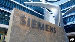 FILE -The logo of German industrial conglomerate Siemens is pictured at the headquarters in Munich, Germany. 