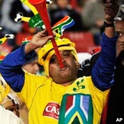 South African fans show their enthusiasm by blaring vuvuzela trumpets