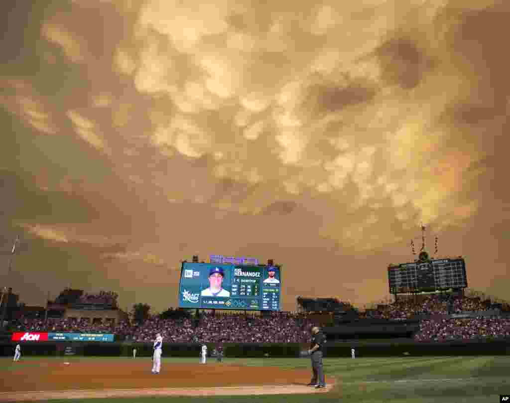Clouds form over Wrigley Field during the fifth inning of a baseball game between the Chicago Cubs and the Los Angeles Dodgers in Chicago, Illinois, USA, June 22, 2015.