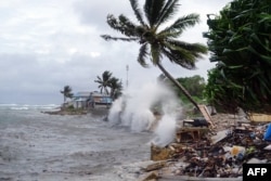 FILE - This picture taken on November 27, 2019 shows waves hitting the shore in Majuro, the capital city of the Marshall Islands. (Photo by Hilary HOSIA / AFP)