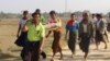 FILE - Residents carry the body of an ethnic Rakhine woman for burial in Rathedaung township, after fresh fighting in Rakhine state between the Myanmar military and the Arakan Army, an ethnic Rakhine force, Feb. 21, 2019.