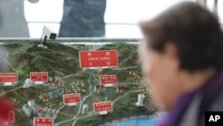 A visitor looks at a map of North Korean towns at the unification observatory in Paju, South Korea, April 25, 2017.