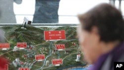 A visitor looks at a map of North Korean towns at the unification observatory in Paju, South Korea, April 25, 2017.