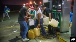 Residents pilfer gasoline and diesel from a gas station following protests against an increase in fuel prices in Allende, southern Veracuz state, Mexico, Jan. 3, 2017. Nationwide protests continued as small groups shut down or looted gas stations and blocked roads to protest a price deregulation.