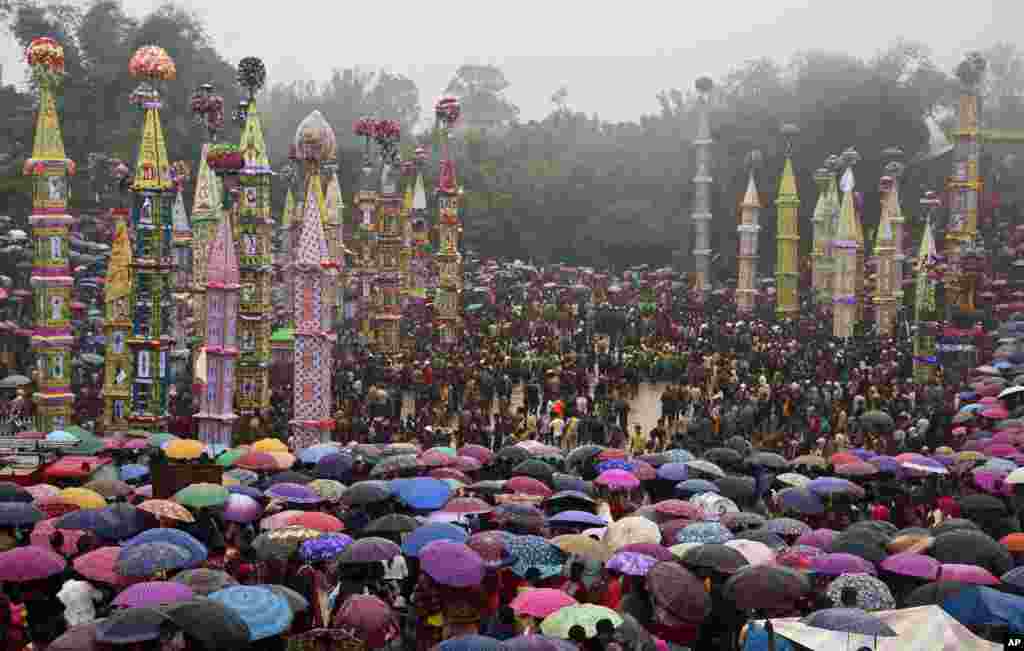 Indian Pnar, or Jaintia tribesmen, carry 'Rongs' (chariots) and dance in muddy waters during Behdienkhlam festival celebrations at Tuber village, in the northeastern Indian state of Meghalaya. Behdienkhlam is a traditional festival of the Pnars celebrated after sowing is done, seeking a good harvest and to drive away plague and diseases.