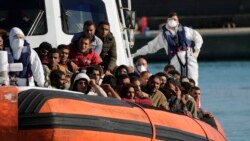 Migrants and refugees enter in the port of Roccella Jonica, Calabria region, southern Italy, Nov. 14, 2021.